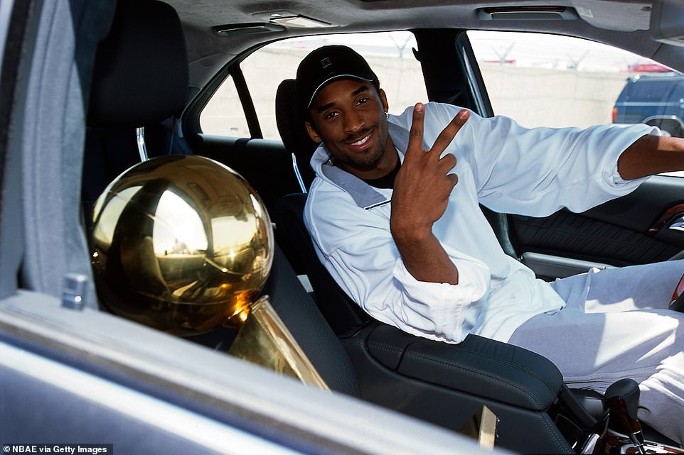 The photos emerged after the world mourned the loss of Bryant over the past week, most recently at Sunday's Super Bowl where a moment of silence was taken to commemorate all victims of the crash, as teams stood on their respective 24-yard lines - in tribute to Bryant's No. 24 jersey. Pictured: Bryant driving home with the NBA Championship trophy in 2001