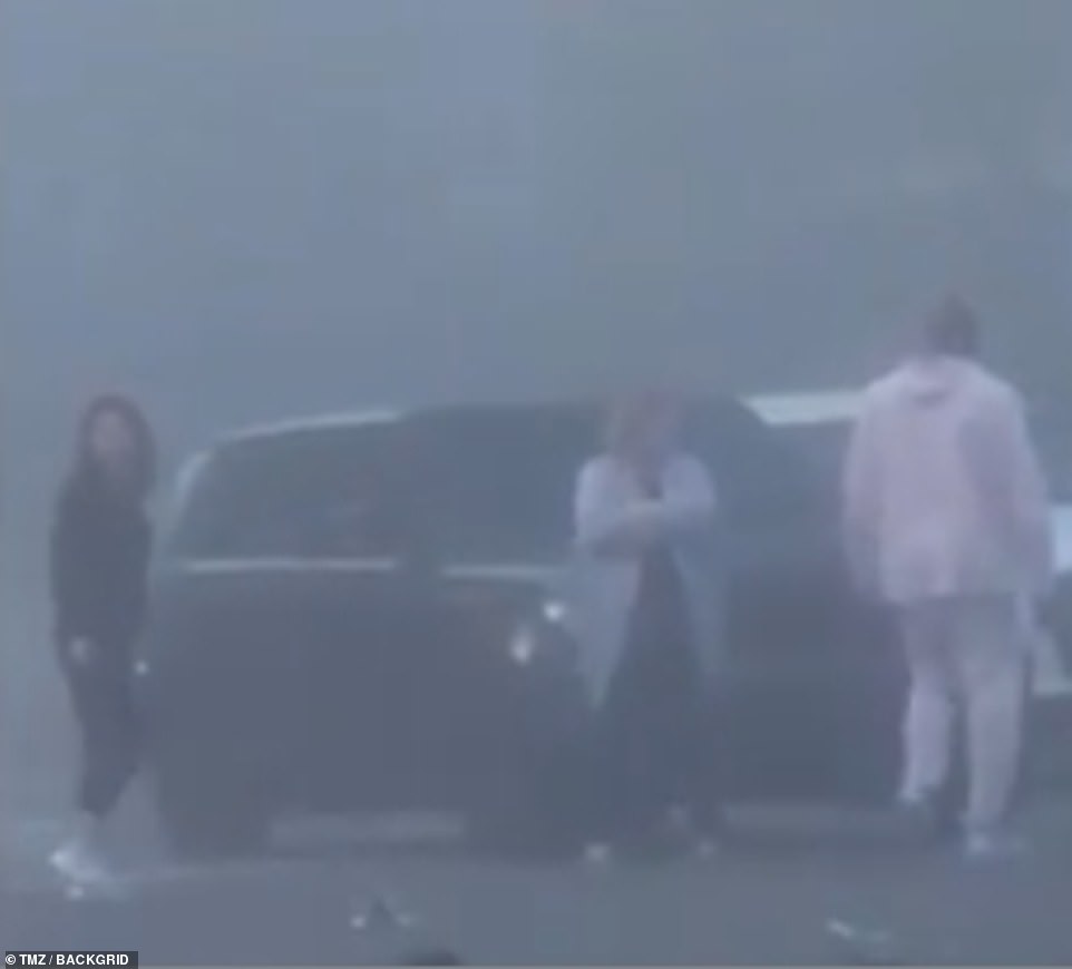 In a resurfaced video after Bryant's death, the father-of-four (in pink) is seen back in December helping out at the scene of a car crash in Newport Beach, before climbing back in his Range Rover (pictured)