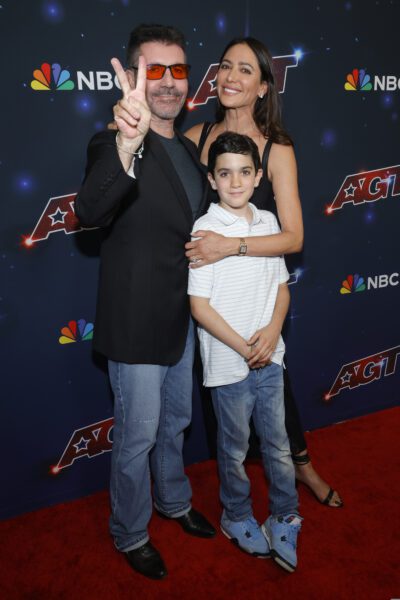 Simon Cowell, Lauren Silverman, and their son Eric on the red carpet