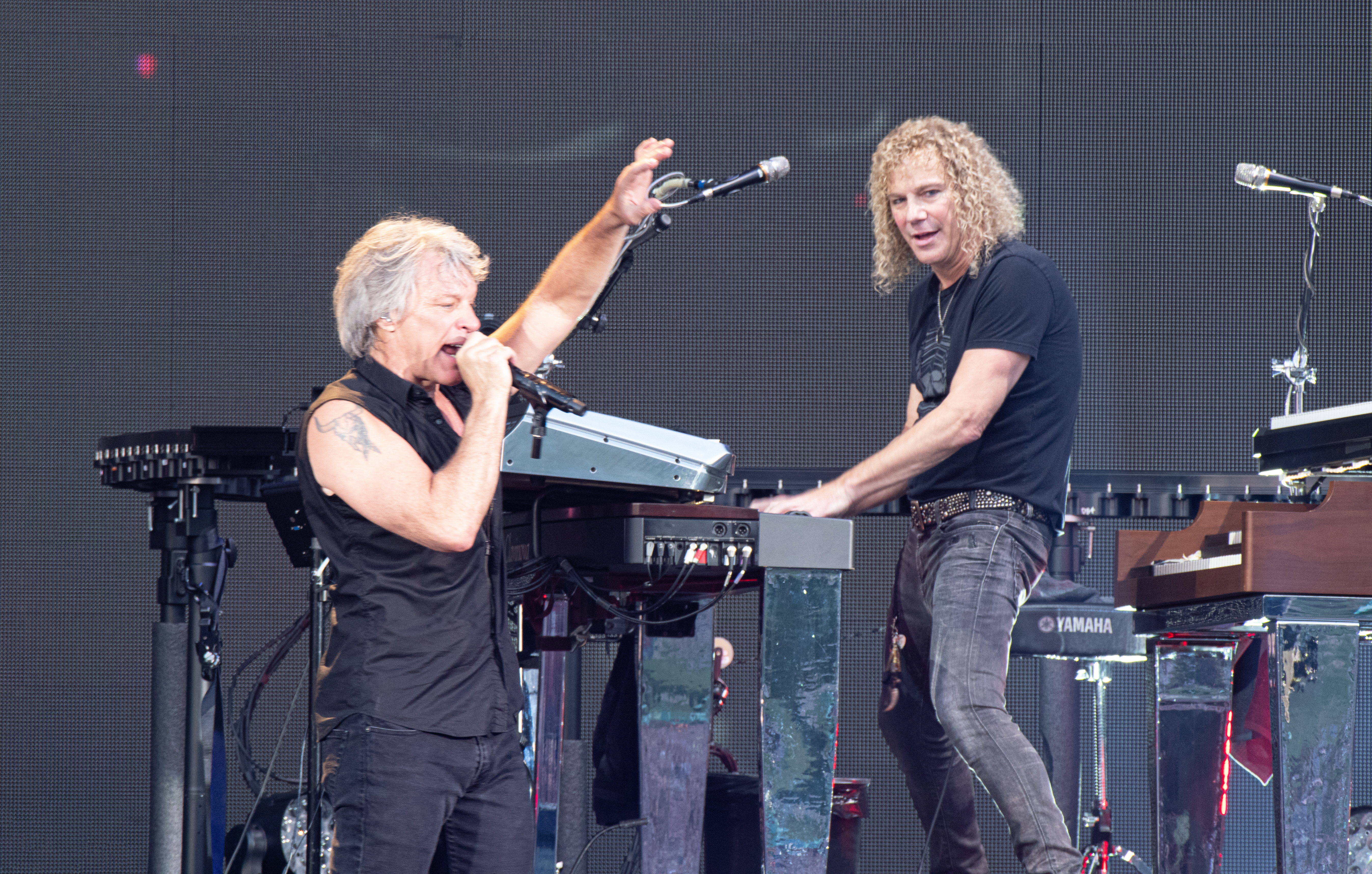 Jon Bon Jovi and David Bryan performing.