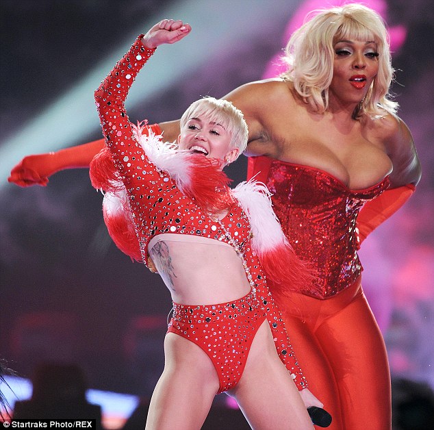 Crazy antics: At one point, Miley was joined on stage by a performer almost twice her height