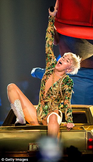 Reach for the sky: Miley is on good form as she performs on Thursday