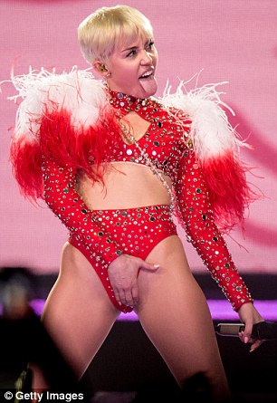 It's that time again: Miley grabs her crotch after switching outfits during Thursday's California show