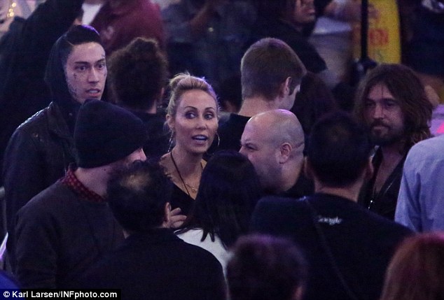 Supportive: Trace Cyrus (far left), Tish Cyrus (centre) and Billy Ray Cyrus (far right) attend the show