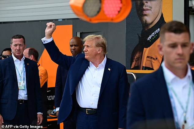 Trump gestured to his supporters in the crowd as he prepared to watch the racing begin