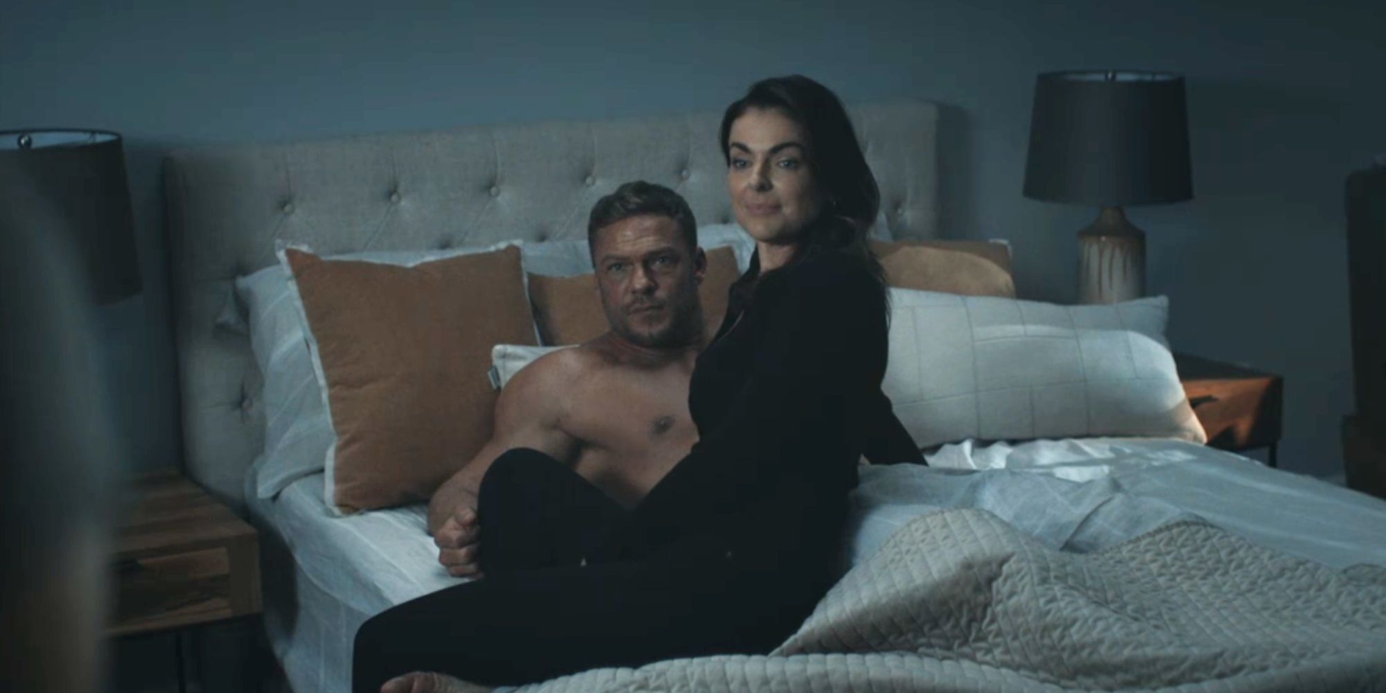 Serinda Swan as Dixon sitting on the bed of Ben Ritchson's Reacher