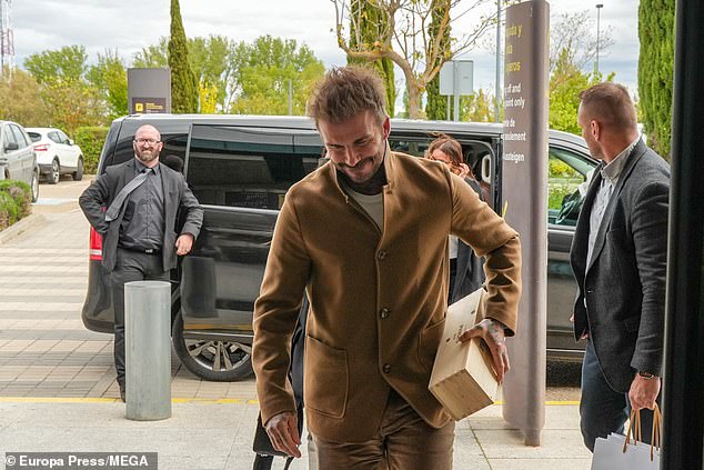 Putting on a stylish display, David opted for a tan brown button up jacket and matching brown trousers