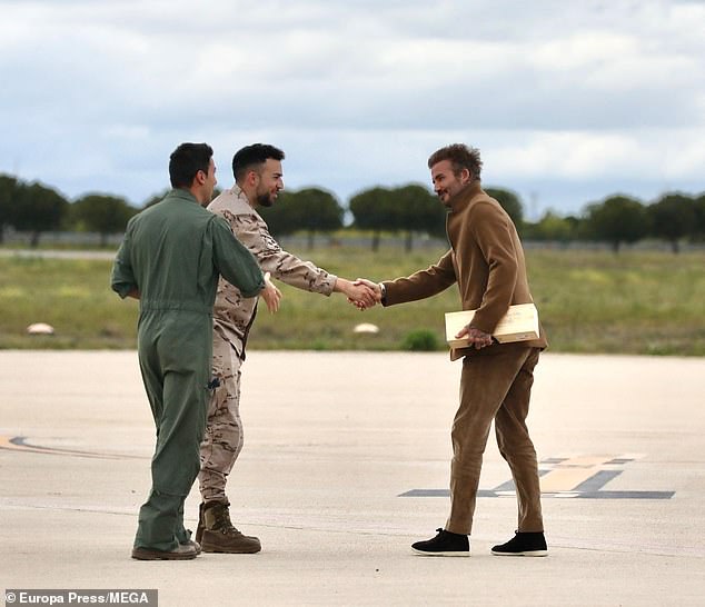 The former footballer appeared in great spirits as he shook hands with the airport staff