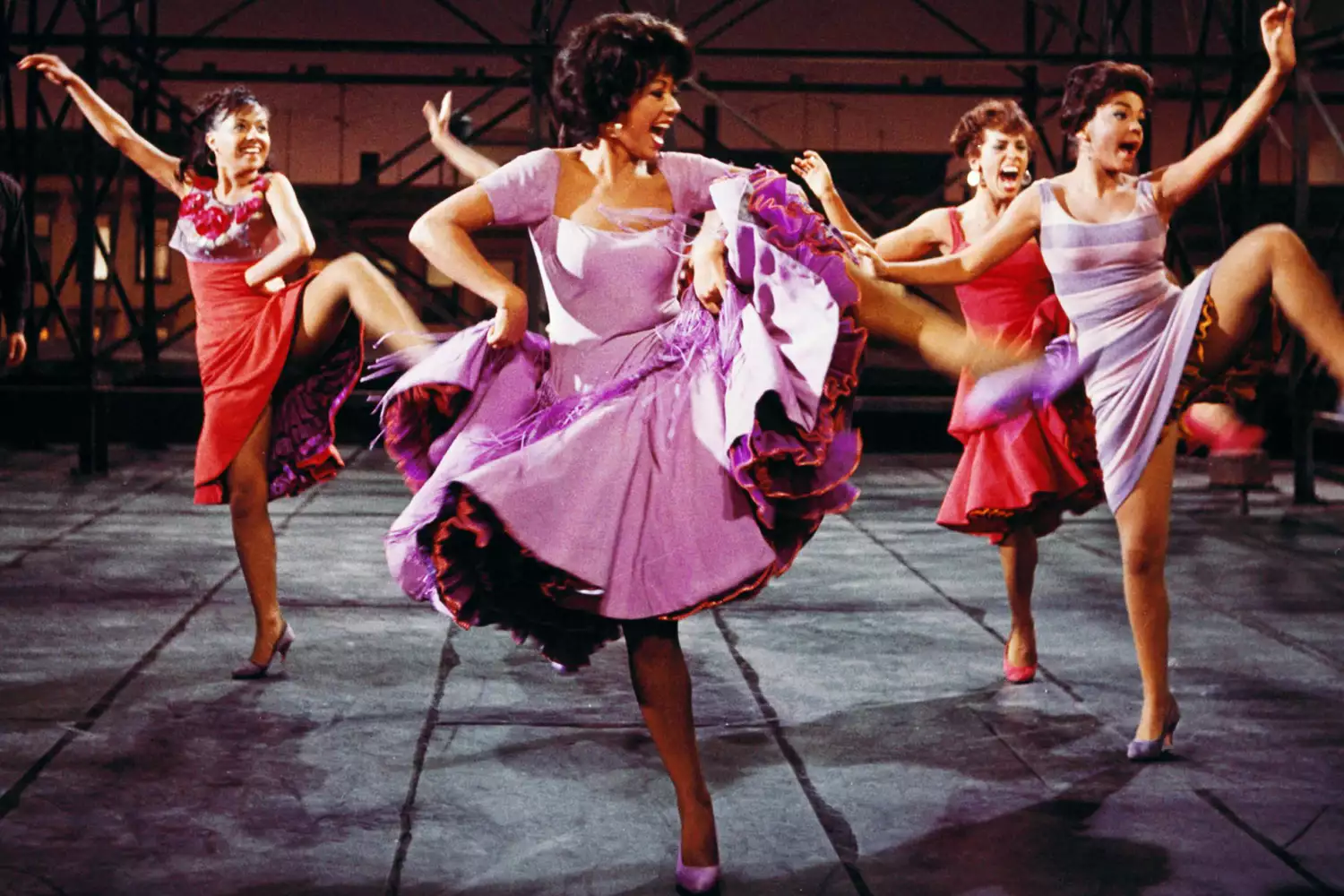 Rita Moreno, Puerto Rican actress, singer and dancer, wearing a short-sleeved lilac dress, dancing in a publicity image issued for the film adaptation of 'West Side Story', USA, 1961