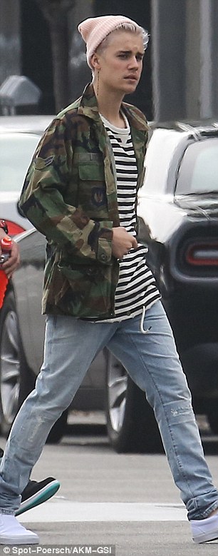 Relaxed: The Candian star wore a camouflage jacket over a striped top