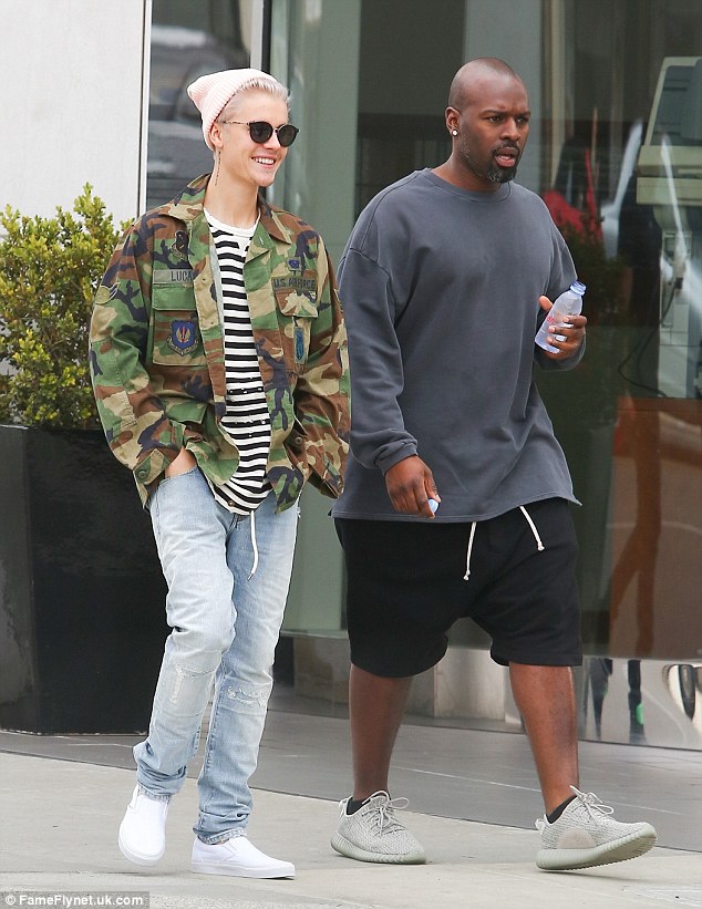 Staying cool: Justin was dressed down in light blue, distressed jeans and a camouflage jacket over a striped top during the low-key outing