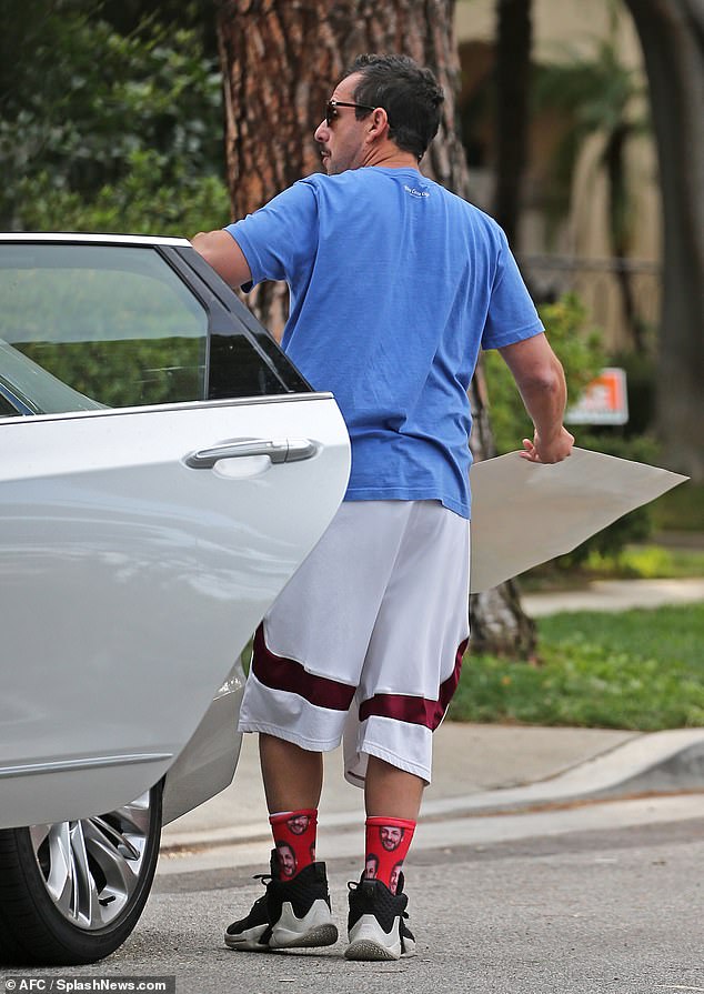 Face it: Sandler, 53, wore his red $12.95 socks with white Air Jordans and a casual outfit of blue T-shirt and oversized white basketball shorts