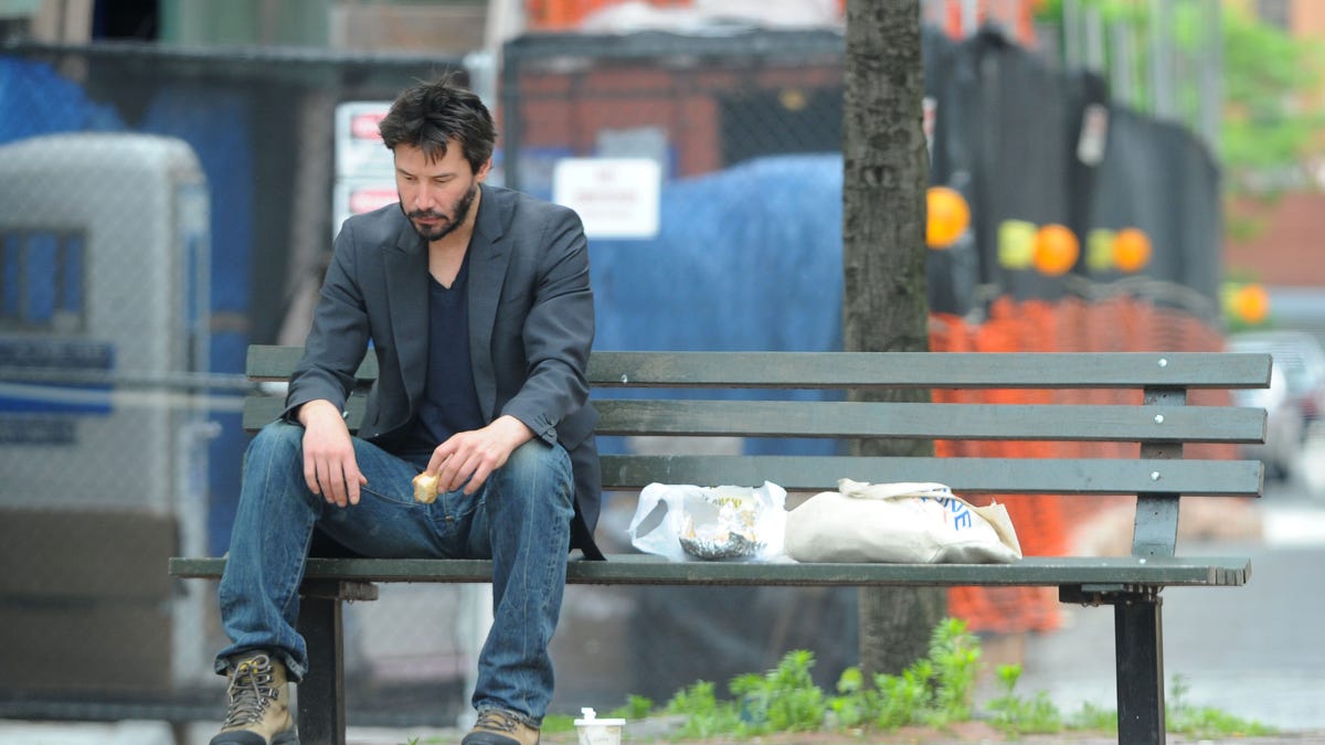 Keanu Reeves eats a sandwich