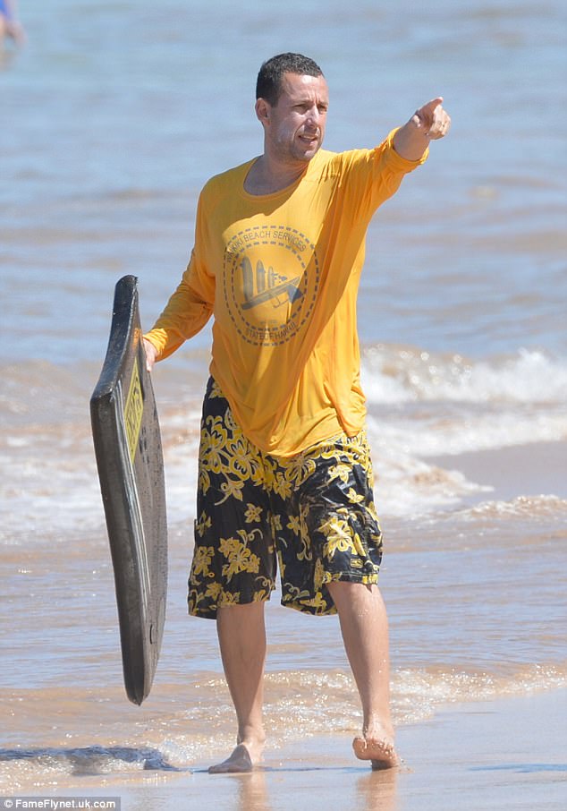 Let's go! The funny man sported a bright yellow long-sleeve shirt and swimming trunks