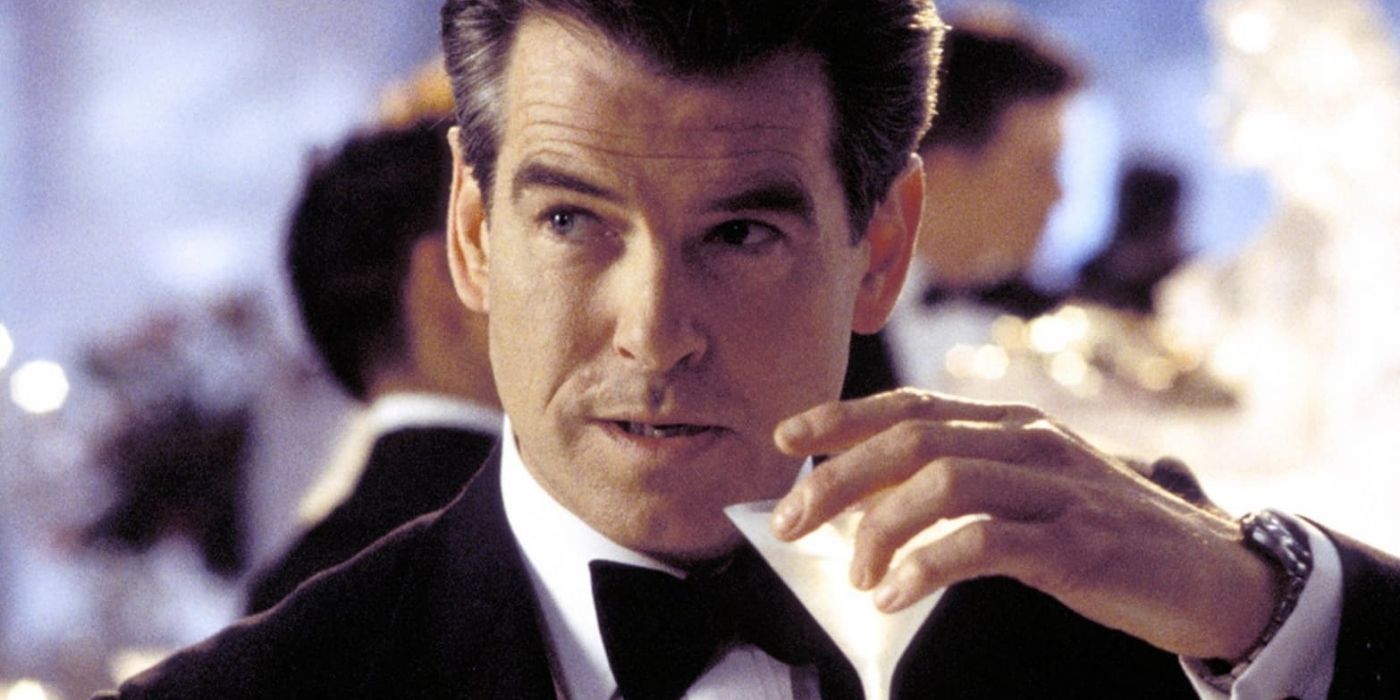 Pierce Brosnan's James bond at a party drawing a martini in for a drink.