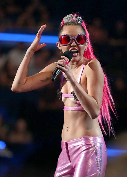 Host Miley Cyrus, styled by Simone Harouche, speaks onstage during the 2015 MTV Video Music Awards at Microsoft Theater on August 30, 2015 in Los...