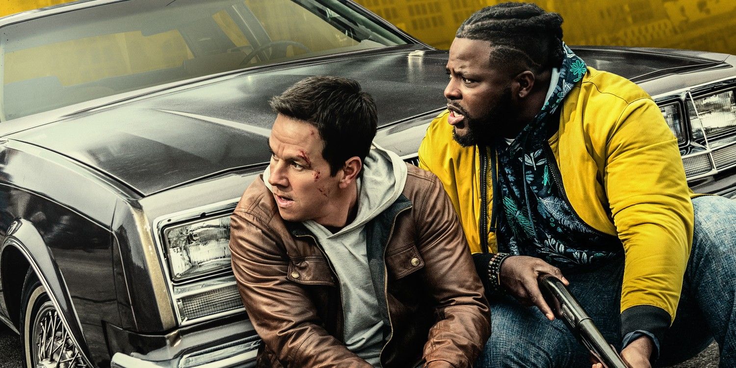 Mark Wahlberg and Winston Duke camping in front of a car in Spenser Confidential