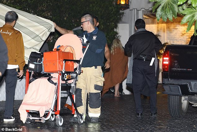 Britney wandered in the background with her entourage at the hotel