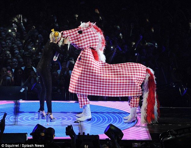 Just horsing around: The 21-year-old clowned around with a gingham pony