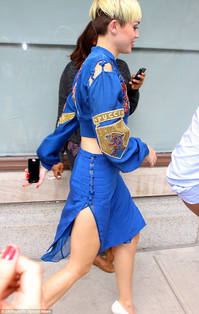 The thigh's the limit: Meanwhile, the matching blue skirt was made of silk with a sheer overlay and featured two slits at each side, showing off the singer's legs