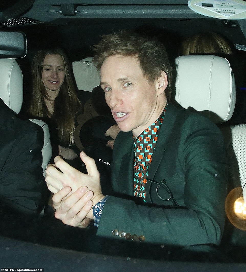 Smart: Eddie sported a dark green blazer with a matching printed shirt