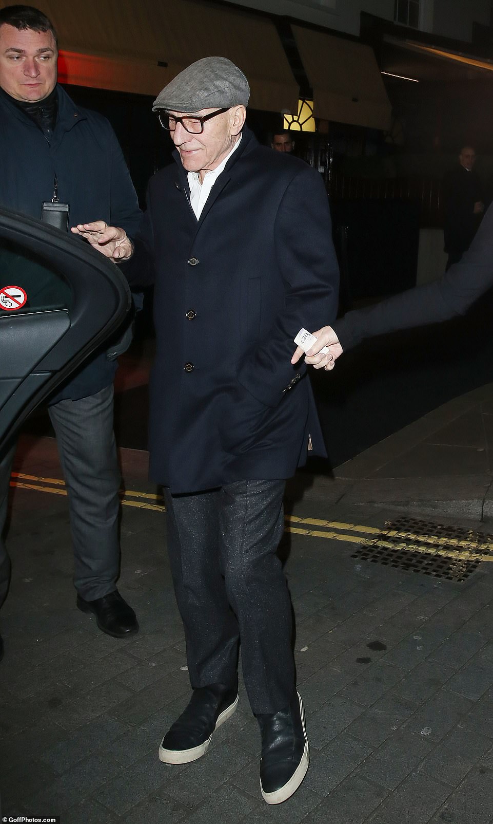 Casual: Patrick Stewart wrapped up in a navy coat which he paired with a white shirt and black trousers