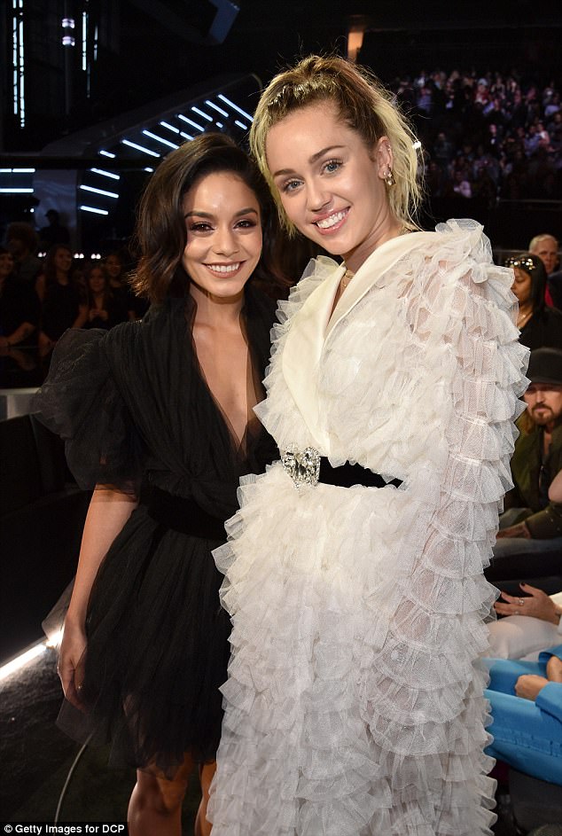 They go back: Miley Cyrus hugged longtime pal Vanessa Hudgens at the Billboard Awards on Sunday in Las Vegas