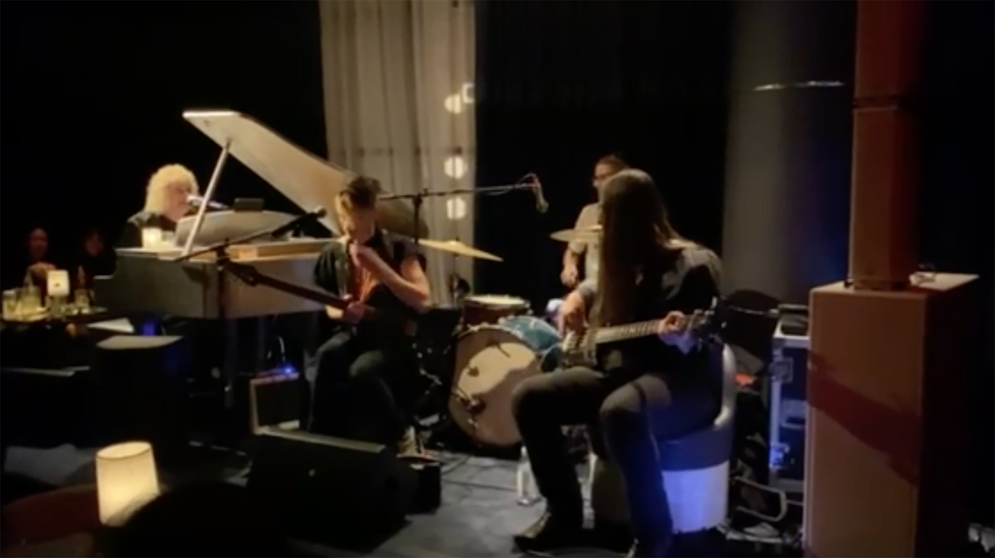 David Bryan playing a piano with a house band.