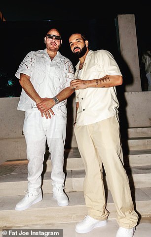 Independence Day drink: The hip-hop star was seen having a drink as he posed for photos next to rapper Fat Joe, 51