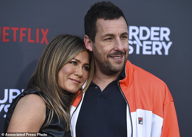 Confession: Jennifer Aniston revealed she had to tell Murder Mystery co-star Adam Sandler to 'oil up his beard' before kissing scene; the longtime friends are pictured at the Los Angeles premiere of the Netflix film on June 10