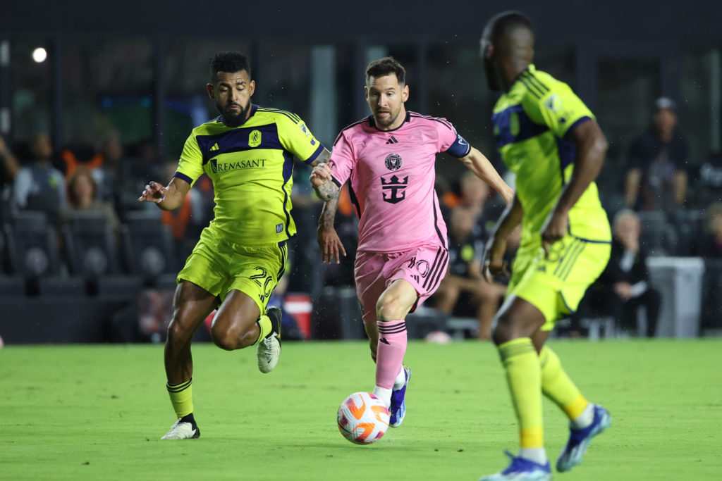 Inter Miami forward Lionel Messi (10) attacks with the ball as Nashville SC midfielder Anibal Godoy (20) defends in the first half during the game ...