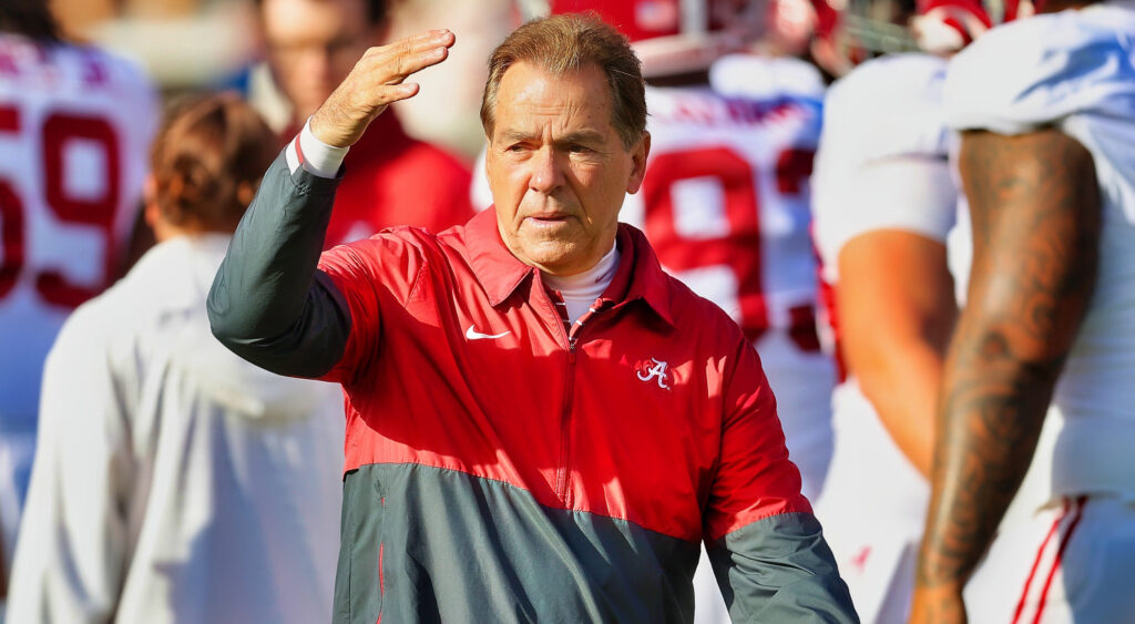 Nick Saban with a hand up