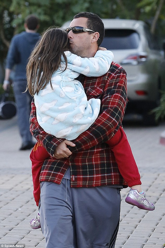 Big Daddy cool: Adam Sandler gave his daughter sunny a tender smooch as he carried her in Malibu Sunday