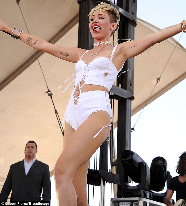 Back to her old tricks: Miley Cyrus is back in her underwear with her tongue out as she performs at the iHeartRadio Music Festival  in Las Vegas on Saturday