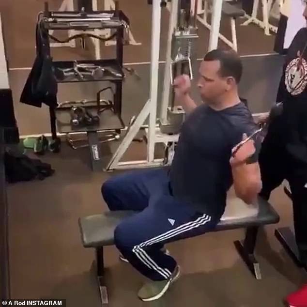 Couple's workout: The baseball star also worked on his biceps as the couple were watched over by a trainer