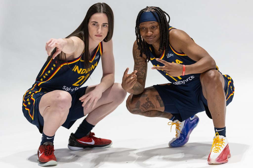 Caitlin Clark #22 and Erica Wheeler #17 of the Indiana Fever pose for photographers during media day activities at Gainbridge Fieldhouse on May 1, 2024 in Indianapolis, Indiana. 