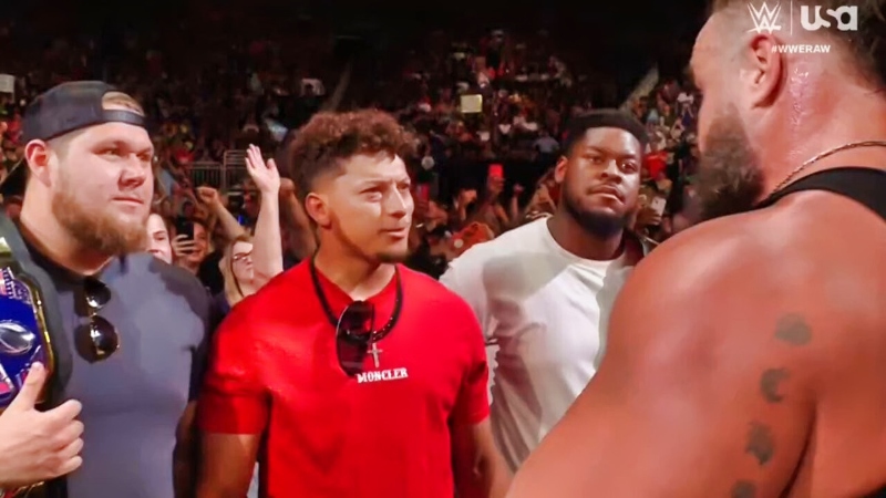 Patrick Mahomes and Braun Strowman looking on at WWE "Monday Night Raw."