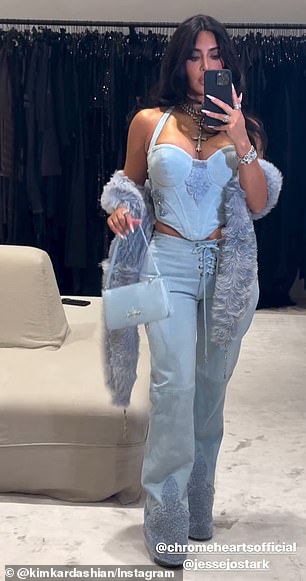 Sister Kim, 43, donned a light blue denim corset top with with glittering, cross-shaped embellishments on each side