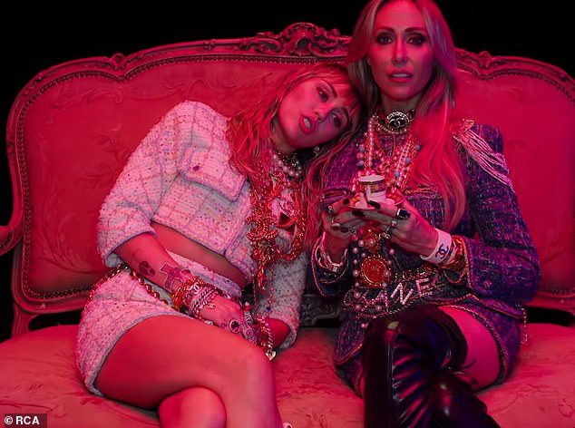 Mama's girl: The visual also features her mother Tish Cyrus, with whom she wore matching Chanel