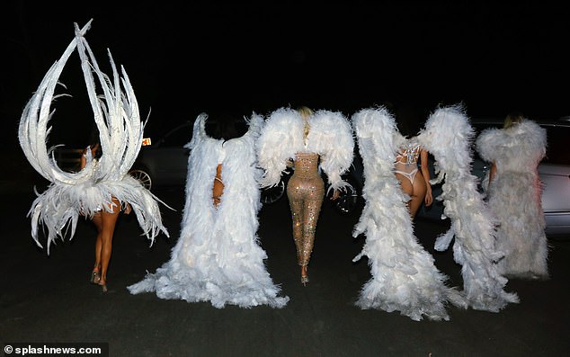 Peachy: The brunette appeared to teach her sisters a thing or two about the Victoria's Secret role as they strutted their stuff along the car park