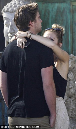 Cuddling up: Miley and Liam looked particularly affectionate as they spent time together