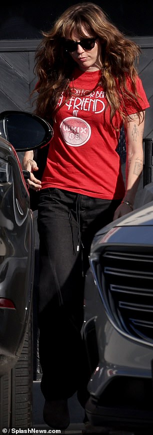 For her latest sighting, Miley cut a casual figure in a cherry red t-shirt and black jeans, warding off the California rays with sunglasses