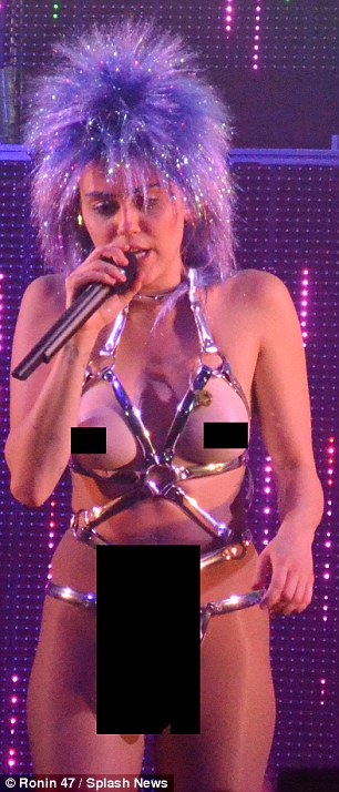 Rebel: At one point the controversial star strutted onto stage in little more than metallic bondage-style underwear and matching thigh-high boots, showing off a pair of fake boobs and the prosthetic penis