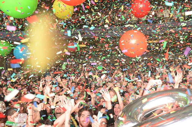 What a crowd: The gig-goers were showered in confetti and colourful balloons during the finale