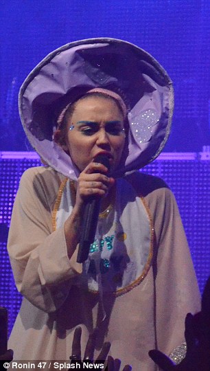 All change: Miley also dressed as a baby and a sparkling moon during the epic gig