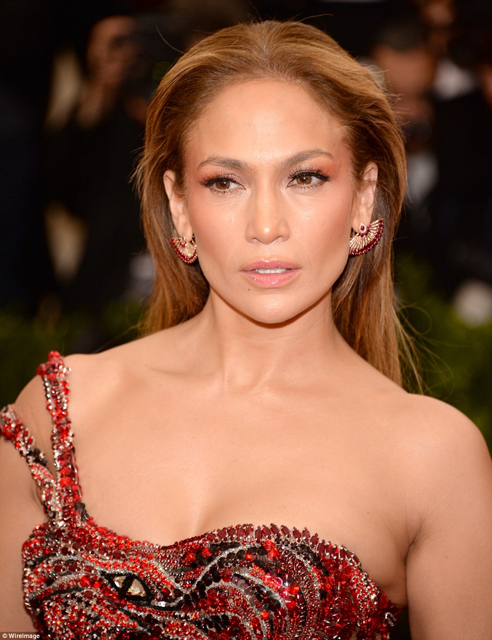 Flawless face: The looker - who will next star on the TV series Shades Of Blue set in NYC - wore her hair down and brushed back revealing diamond and ruby earrings