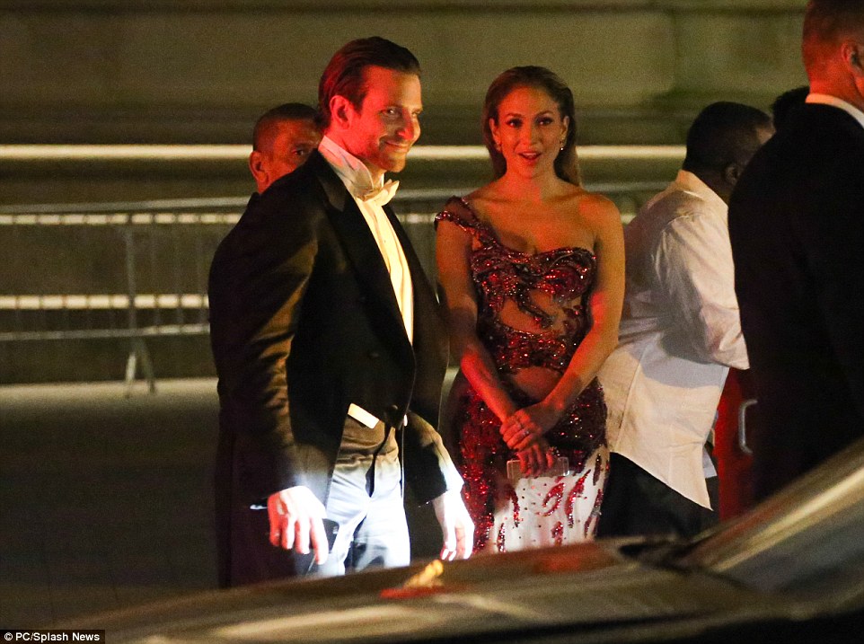 Even stars have to wait for their cars: Jennifer got chatting to actor Bradley Cooper as they left the Gala to head to the afterparties