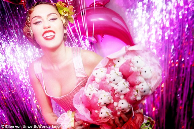 Fancy! The singer/song-writer clutches at a bouquet of small teddy bears in one glamorous shot