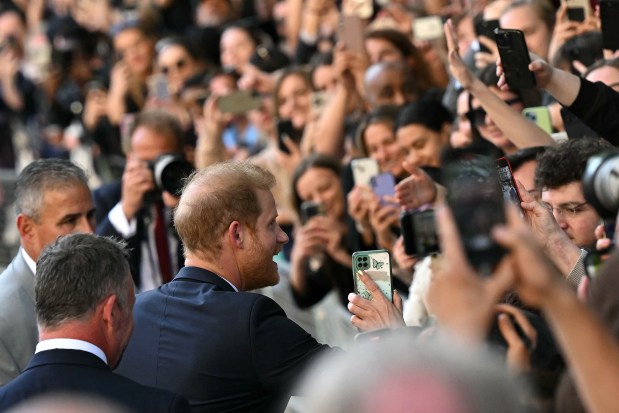 Britain's Prince Harry, Duke of Sussex greets well-wishers as he leaves after attending a ceremony marking the 10th anniversary of the Invictus Games, at St Paul's Cathedral in central London, on May 8, 2024. (Photo by JUSTIN TALLIS / AFP) (Photo by JUSTIN TALLIS/AFP via Getty Images)