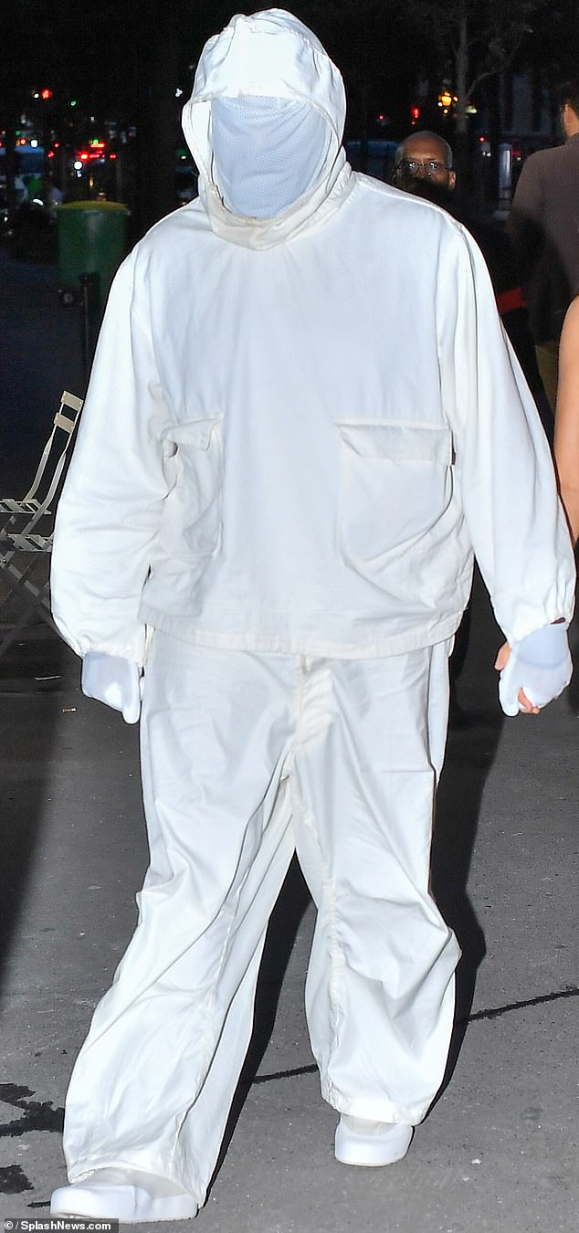 Ye's white suit makes him look like a beekeeper ready to remove a bee hive; oddly his hoodie appeared stained